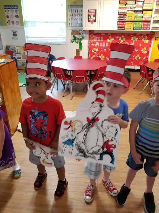 Children wearing tall red and white striped hats for Dr. Seuss day